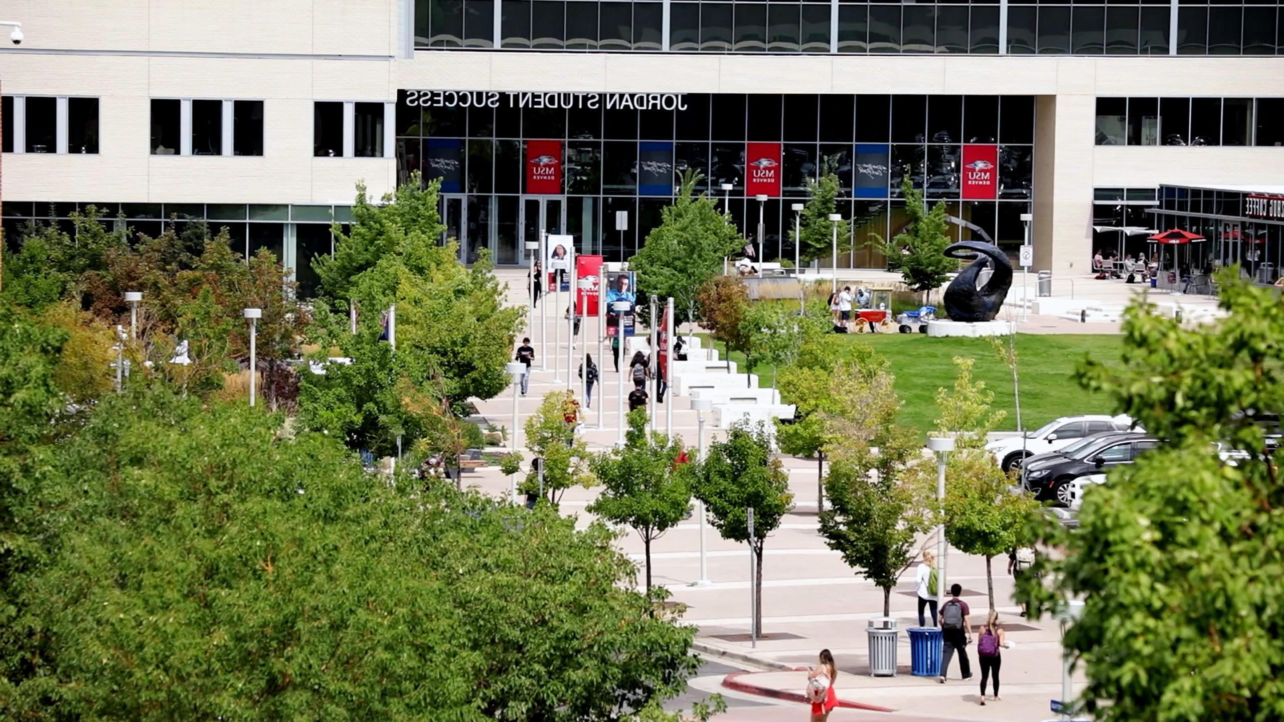 Drone shot of students walking along the path towards the front of the Jordan Student Success Building