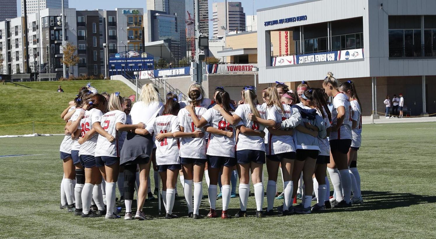 Women's soccer team in huddle