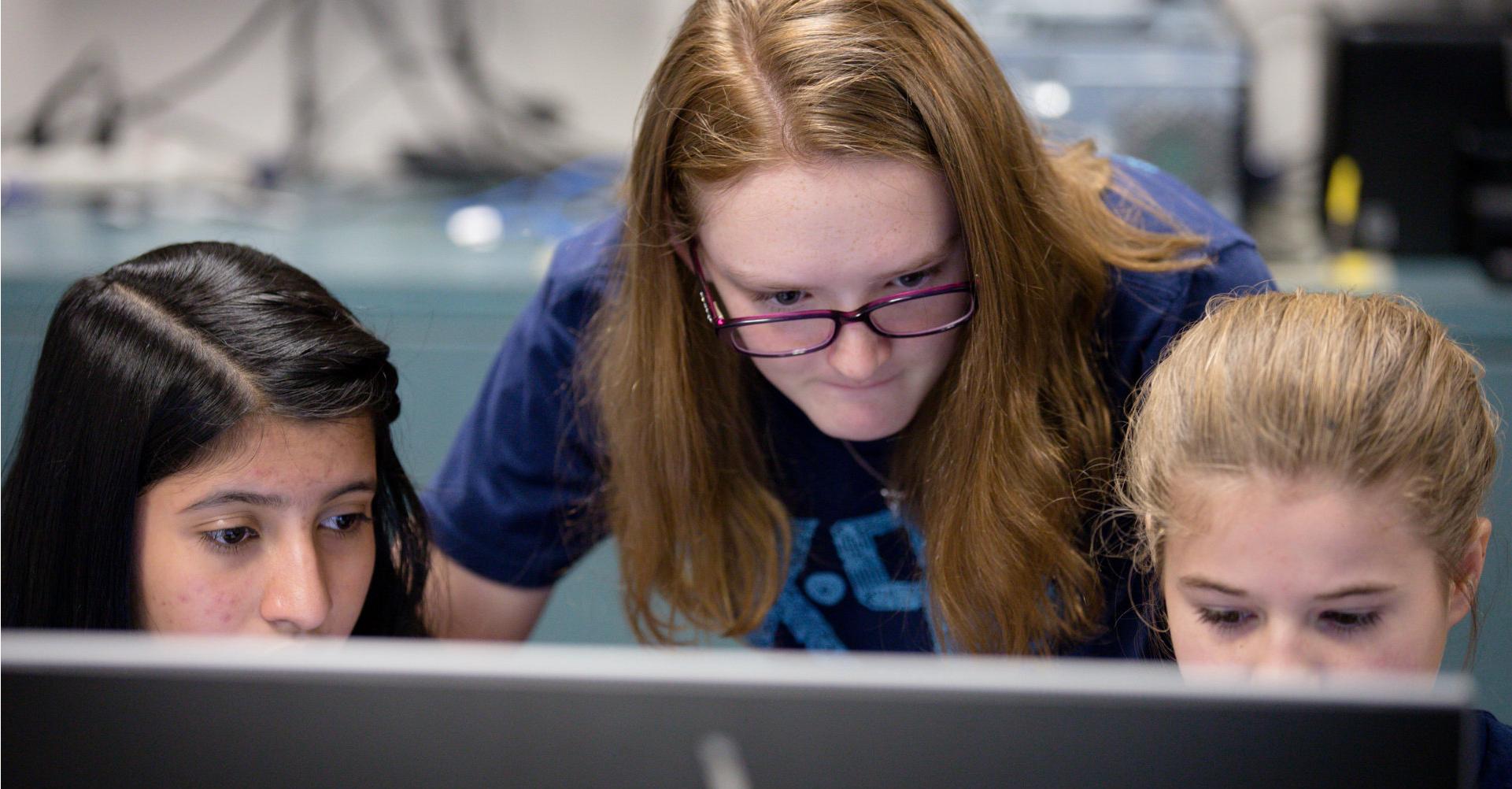 Three female students from D’Evelyn Junior High School code and collaborate their way to the national CyberPatriot competition.