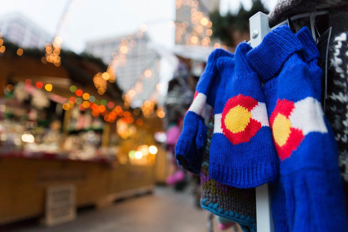 Winter wear with colorado logo in front of holiday lights downtown